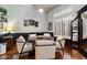 Modern dining room featuring wood floors, neutral walls, wainscoting and white chairs at 42105 N Golf Crest Rd, Anthem, AZ 85086