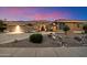 Charming home featuring desert landscaping, two car garage and stone accents enhancing the curb appeal at 42105 N Golf Crest Rd, Anthem, AZ 85086