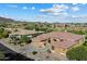 Aerial shot of the home in a picturesque neighborhood with beautiful landscaping and mountain views at 42105 N Golf Crest Rd, Anthem, AZ 85086