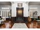 Elegant foyer with wood flooring, a dark front door, white walls and decorative furnishings at 42105 N Golf Crest Rd, Anthem, AZ 85086