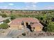 Aerial front view of a home with a desert landscaped front yard, tile roof, and mountain views in the distance at 42105 N Golf Crest Rd, Anthem, AZ 85086