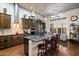 Spacious kitchen with an island, stainless steel appliances, modern lighting, and dark wood cabinets at 42105 N Golf Crest Rd, Anthem, AZ 85086