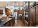 Modern kitchen with dark wood cabinets, stainless steel appliances, and a large island with counter seating at 42105 N Golf Crest Rd, Anthem, AZ 85086