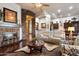 Spacious living room features a stone fireplace, modern furniture, and an open concept to the kitchen at 42105 N Golf Crest Rd, Anthem, AZ 85086
