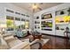 Bright and airy living room with custom built-in shelving, comfortable seating, and large windows at 42105 N Golf Crest Rd, Anthem, AZ 85086