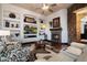 Cozy living room with a fireplace, built-in shelves, and comfortable seating at 42105 N Golf Crest Rd, Anthem, AZ 85086