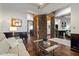 Bright living room showcasing wood floors, stone columns, modern furniture and neutral walls at 42105 N Golf Crest Rd, Anthem, AZ 85086