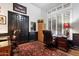 Dedicated home office space with wood paneling and a functional desk area at 42105 N Golf Crest Rd, Anthem, AZ 85086