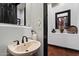 Stylish powder room featuring a vessel sink, decorative mirror, and elegant accents at 42105 N Golf Crest Rd, Anthem, AZ 85086