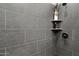 Modern shower adorned with sleek gray tile and a niche for toiletries and décor at 42105 N Golf Crest Rd, Anthem, AZ 85086