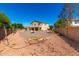 Expansive backyard with gravel, pool, and patio, offering ample space for outdoor activities and entertaining at 42616 W Avella Dr, Maricopa, AZ 85138