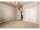 This bedroom has an ensuite bathroom and closet, neutral carpet, and a ceiling fan at 42616 W Avella Dr, Maricopa, AZ 85138