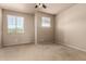 A bedroom with neutral paint, carpet, and two windows offering great natural light at 42616 W Avella Dr, Maricopa, AZ 85138
