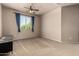 This is a simple bedroom with a ceiling fan and neutral paint to suit any decor at 42616 W Avella Dr, Maricopa, AZ 85138