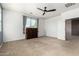 A neutral carpet and great lighting make this bedroom feel spacious and inviting at 42616 W Avella Dr, Maricopa, AZ 85138