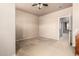 Spacious bedroom with neutral walls, carpet flooring, and a ceiling fan, perfect for relaxation at 42616 W Avella Dr, Maricopa, AZ 85138