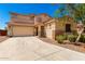A charming two-story home with a neutral color scheme, a two-car garage, and desert landscaping at 42616 W Avella Dr, Maricopa, AZ 85138