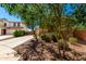 View of a two-story home's front exterior with desert landscaping, and a long driveway at 42616 W Avella Dr, Maricopa, AZ 85138