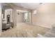 Open-concept living room with neutral color palette, plush carpeting, and lots of natural light at 42616 W Avella Dr, Maricopa, AZ 85138