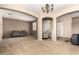 Spacious living room with neutral paint, plush carpeting, and natural light at 42616 W Avella Dr, Maricopa, AZ 85138