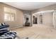 Cozy living room with neutral walls, archways, plush carpeting, and comfortable seating at 42616 W Avella Dr, Maricopa, AZ 85138