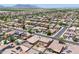 Expansive aerial view of a well-planned community with tile roofs and solar panels against a mountain backdrop at 45647 W Starlight Dr, Maricopa, AZ 85139