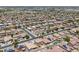 Detailed aerial view of a vast residential neighborhood featuring tile roofs and solar panels, showcasing community layout at 45647 W Starlight Dr, Maricopa, AZ 85139