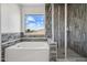 Luxurious bathroom featuring a soaking tub and separate shower at 45647 W Starlight Dr, Maricopa, AZ 85139