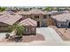 Two-story home featuring a well-manicured front yard and a tile roof at 45647 W Starlight Dr, Maricopa, AZ 85139