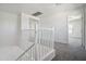 Bright hallway featuring neutral colored carpet and white railings at 45647 W Starlight Dr, Maricopa, AZ 85139