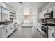 Bright and stylish kitchen with white cabinetry, stainless steel appliances, and a functional center island at 45647 W Starlight Dr, Maricopa, AZ 85139