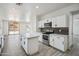 Bright kitchen features an island, stainless steel appliances and modern backsplash at 45647 W Starlight Dr, Maricopa, AZ 85139