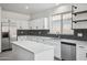 Spacious kitchen featuring modern appliances, white cabinets, and quartz counters at 45647 W Starlight Dr, Maricopa, AZ 85139
