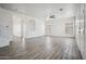 Bright living room with wood-look tile floors, neutral walls, and modern ceiling fan; inviting and spacious at 45647 W Starlight Dr, Maricopa, AZ 85139
