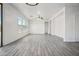 Spacious living room with wood-look tile and many windows at 45647 W Starlight Dr, Maricopa, AZ 85139