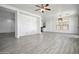 Bright and airy living area with wood-look tile flooring and neutral paint at 45647 W Starlight Dr, Maricopa, AZ 85139