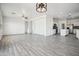 Open floor plan with wood-look tile and modern light fixture at 45647 W Starlight Dr, Maricopa, AZ 85139