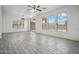 Open living room with wood-look tile floors and natural light at 45647 W Starlight Dr, Maricopa, AZ 85139