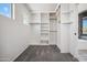 Walk-in closet featuring built-in shelving and ample storage space at 45647 W Starlight Dr, Maricopa, AZ 85139