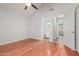 Bright bedroom with hardwood floors, ceiling fan, and access to bathroom and hallway at 4601 N 102Nd Ave # 1020, Phoenix, AZ 85037