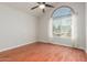 Bedroom featuring hardwood floors, arched window, ceiling fan, and white curtains at 4601 N 102Nd Ave # 1020, Phoenix, AZ 85037