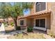 Charming home exterior with tile roof, mature tree, and desert landscaping at 4601 N 102Nd Ave # 1020, Phoenix, AZ 85037