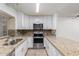 Modern kitchen featuring granite countertops, stainless steel appliances, and white cabinets at 4601 N 102Nd Ave # 1020, Phoenix, AZ 85037
