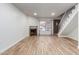 Bright living room with fireplace, tile floors, staircase and a large window providing natural light at 4601 N 102Nd Ave # 1020, Phoenix, AZ 85037