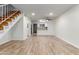 Open-concept living space features tile floors and a view of the staircase, kitchen, and entryway at 4601 N 102Nd Ave # 1020, Phoenix, AZ 85037