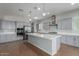 Modern kitchen with stainless steel appliances, gray cabinets and a large kitchen island at 5139 N 185Th Ave, Litchfield Park, AZ 85340