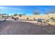 Expansive backyard boasts desert landscaping, a built-in barbeque area, and a cozy seating area at 5316 N 186Th Dr, Litchfield Park, AZ 85340