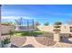 Entertainer's backyard featuring a trampoline, artificial turf, and charming walkway at 5316 N 186Th Dr, Litchfield Park, AZ 85340