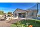 Lush backyard featuring a trampoline, artificial turf, and covered patio at 5316 N 186Th Dr, Litchfield Park, AZ 85340