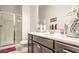 Spacious bathroom with double sinks, large mirror, and glass-enclosed shower at 5316 N 186Th Dr, Litchfield Park, AZ 85340